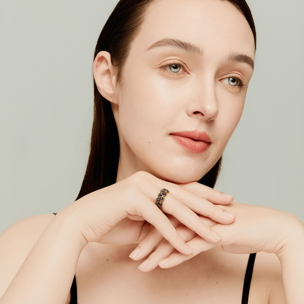 Model wearing 14K gold eternity band with pear-shaped rose-cut black diamonds; bold and luxurious statement piece.