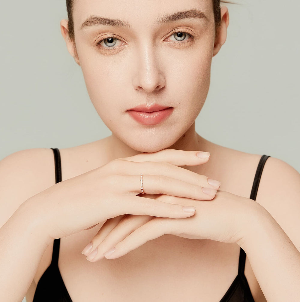 Model wearing a dainty 14K rose gold full eternity ring set with lab-grown diamonds; perfect for stacking and everyday minimalism.