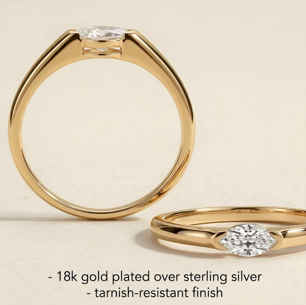 Gold-plated ring with a diamond on a beige background